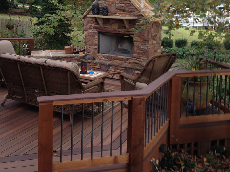 Installed backyard deck with fireplace and patio furniture in Cornelius, North Carolina