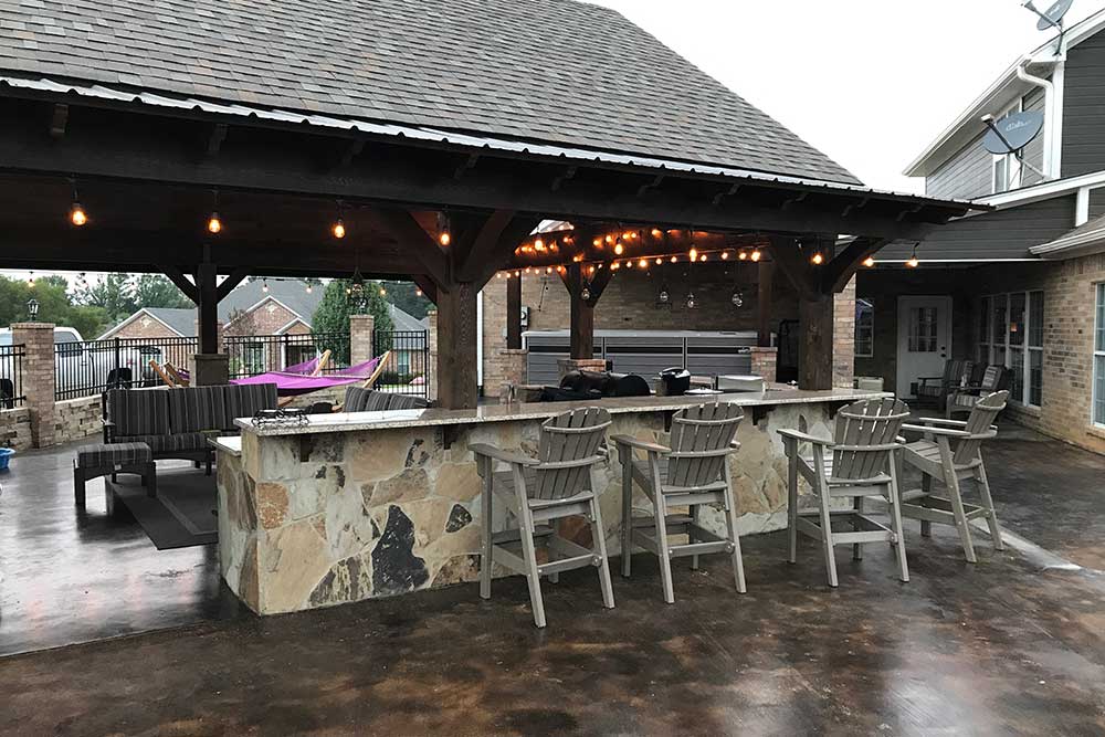 Outdoor kitchen with an Endless Pool swim spa in backround in Charlotte, North Carolina