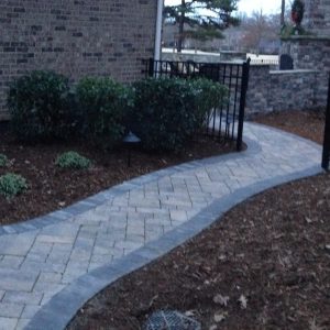 Stone walkway construction and installation along house in Indian Trail, North Carolina