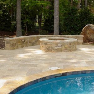 Fun Outdoor Living construction of a stone fire pit poolside