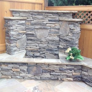 Stacked stone fire pit in backyard