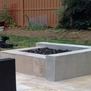 Cement fire pit with rock on patio