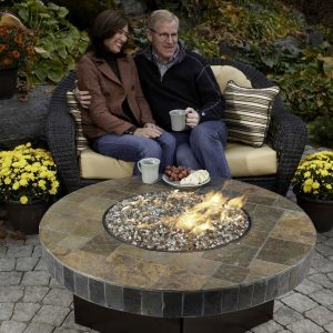 Couple next to a fire table