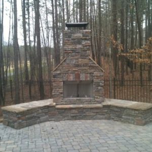 Front view of brick fireplace installation in backyard