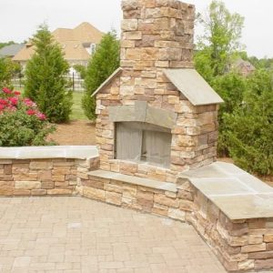 Brick and stone fireplace installation in backyard