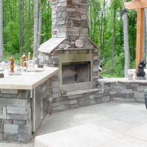 Fun Outdoor Living Brick fireplace construction with an outdoor kitchen