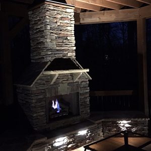 Brick and stone fireplace at night