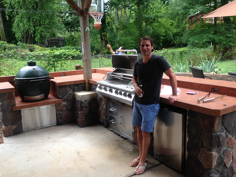 Fun Outdoor Living customer next to his built-in Bull grill in an outdoor kitchen with a Big Green Egg smoker grill in Pineville, North Carolina