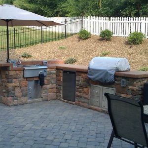 Fireplace and kitchen on outdoor patio in Pineville, North Carolina