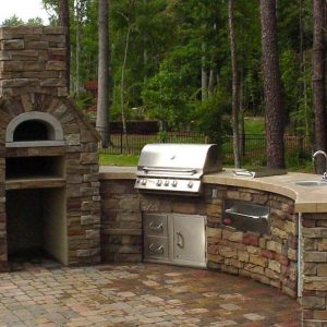 Outdoor fireplace and kitchen on patio in Charlotte, North Carolina