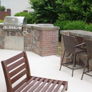 Outdoor stone kitchen with built-in grill in Pineville, North Carolina