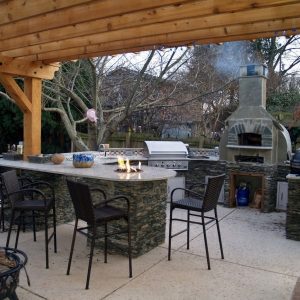 Outdoor kitchen island with fireplace and table fire in Indian Trail, North Carolina