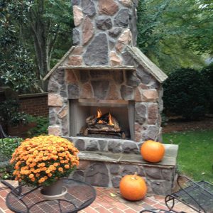 Brick and stone fireplace with pumpkins
