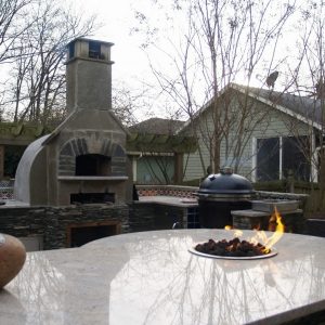 Outdoor kitchen with a pizza oven with Big Green Egg in Charlotte, North Carolina