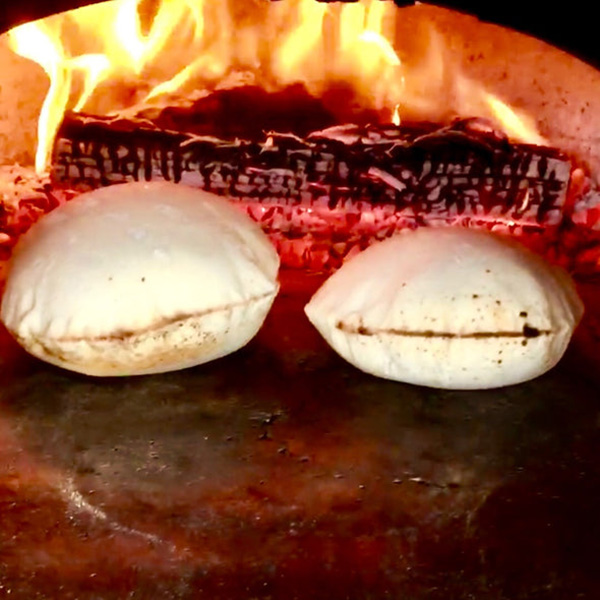 Close up of Pita Bread baking in a fire brick oven