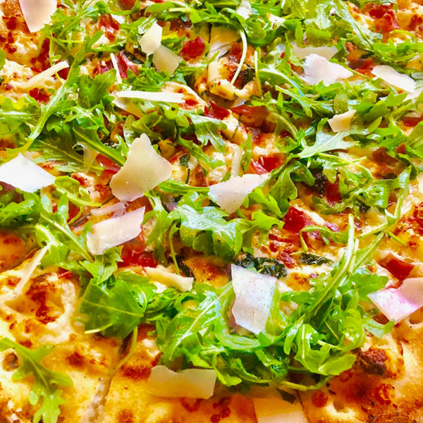 Close-up of pizza with arugula