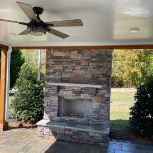 Outdoor Fireplace on patio with ceiling fan