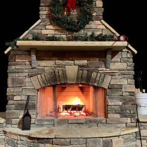 Fireplace outside made of stone with Christmas decorations
