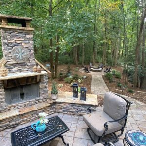 Outdoor fireplace with screen, decorations on a paved patio