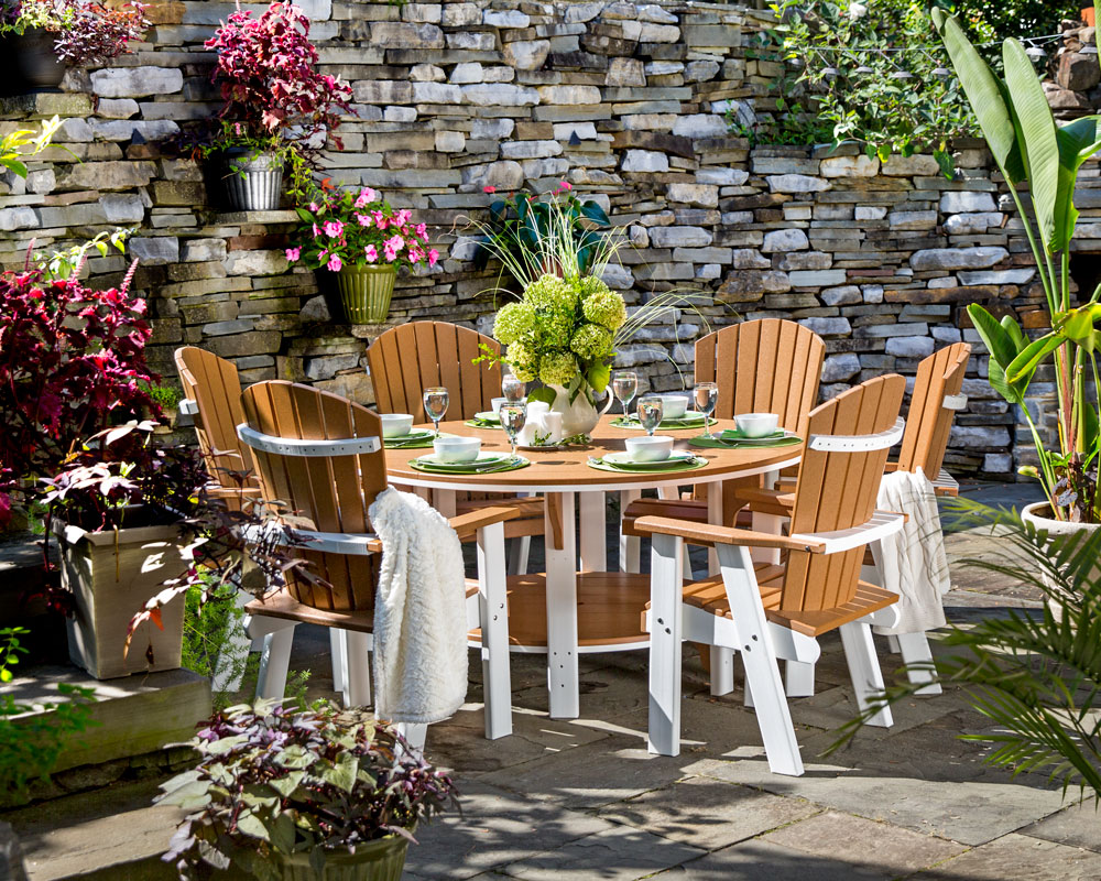 Outdoor dining patio set next to stone wall on paved patio