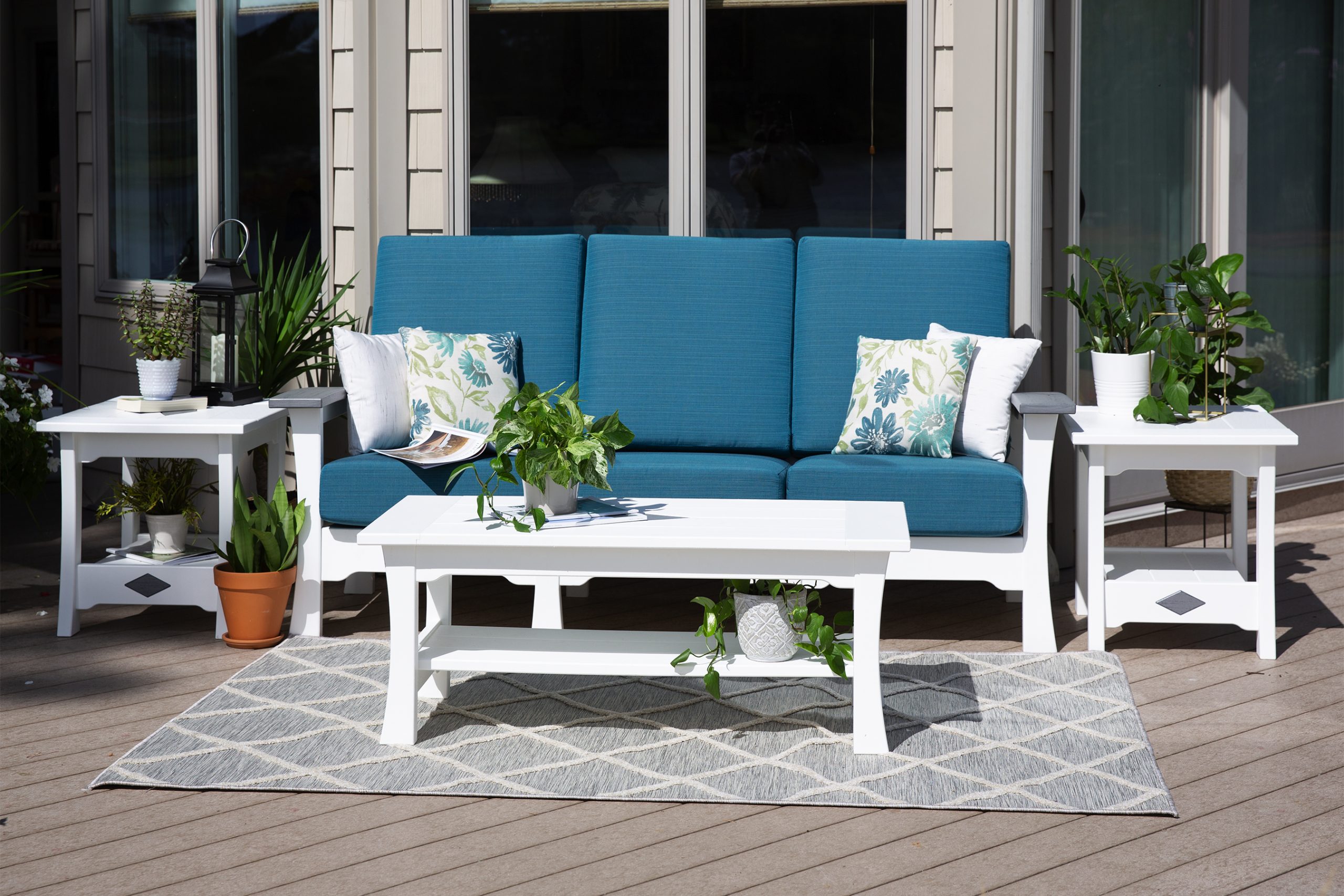 Blue and white outdoor furniture set on rub on top of beautiful deck