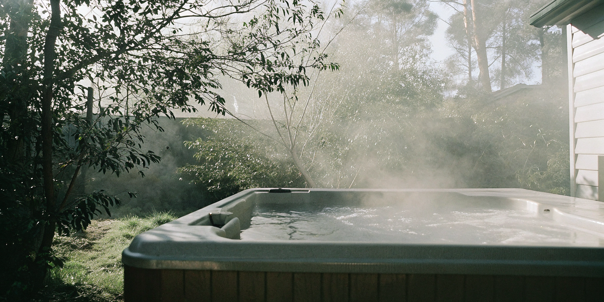A steaming Hot Spring hot tub in a backyard, a popular model featured in hot tub reviews.