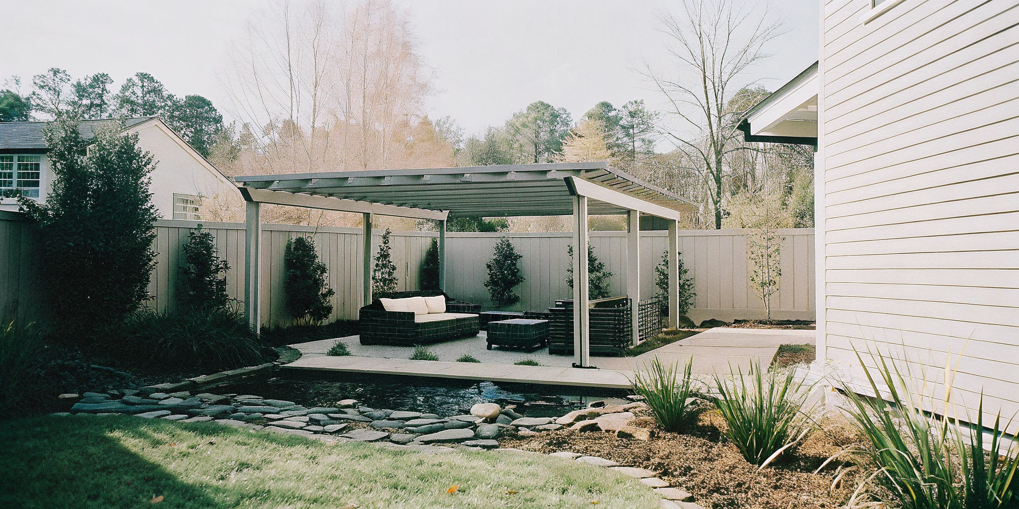 A professionally built outdoor living space by a Charlotte NC contractor with a pergola and patio seating.