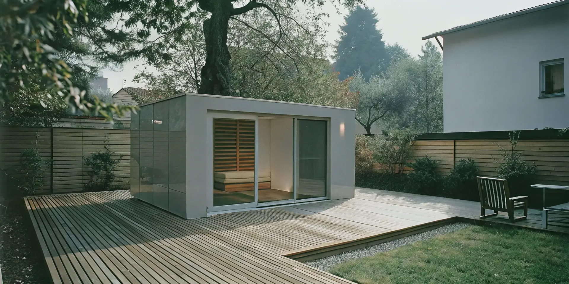 A modern outdoor sauna installed on a wooden deck in a private Charlotte backyard.