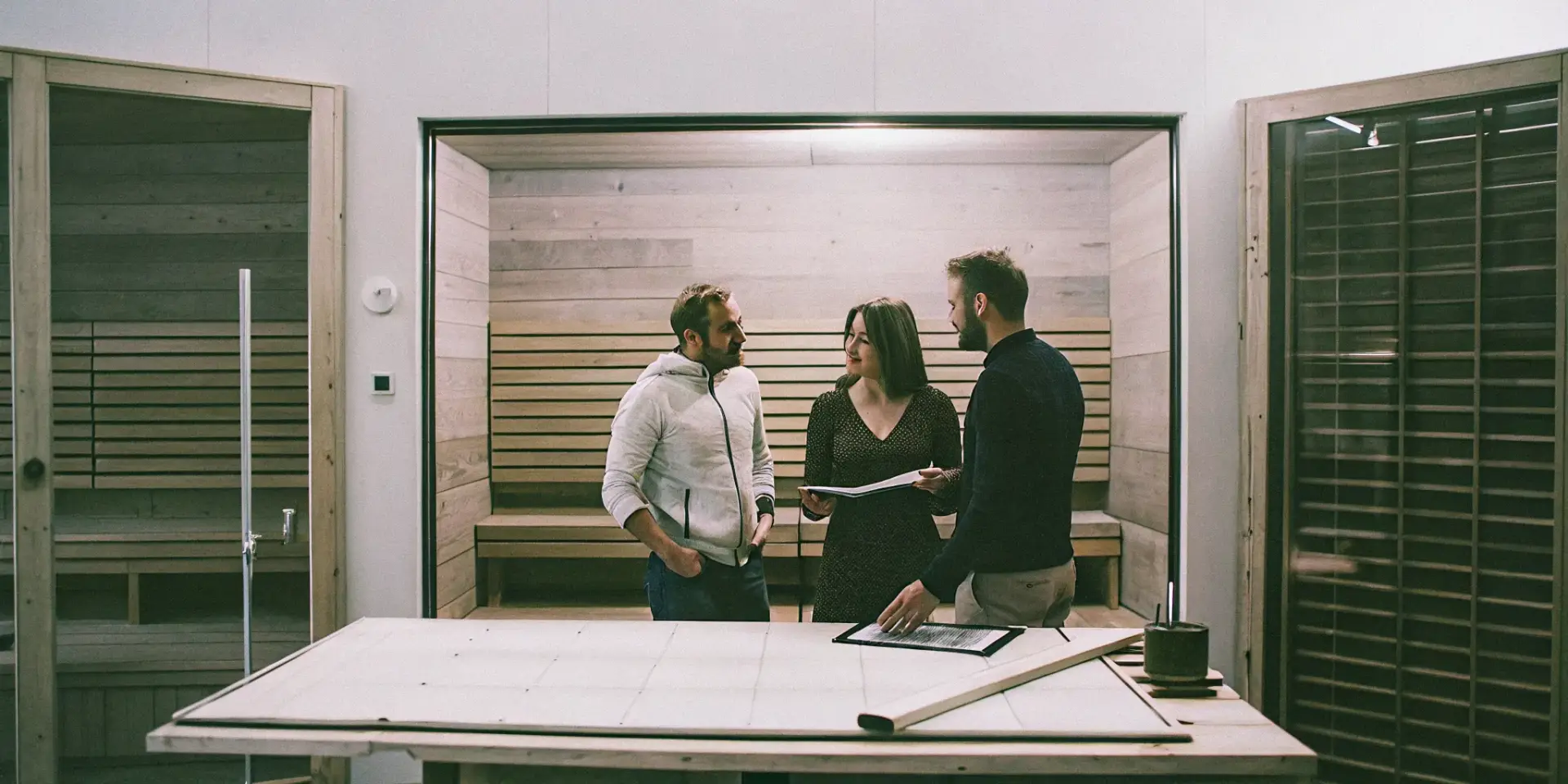 A professional sauna installer reviews design plans with homeowners in Rock Hill.