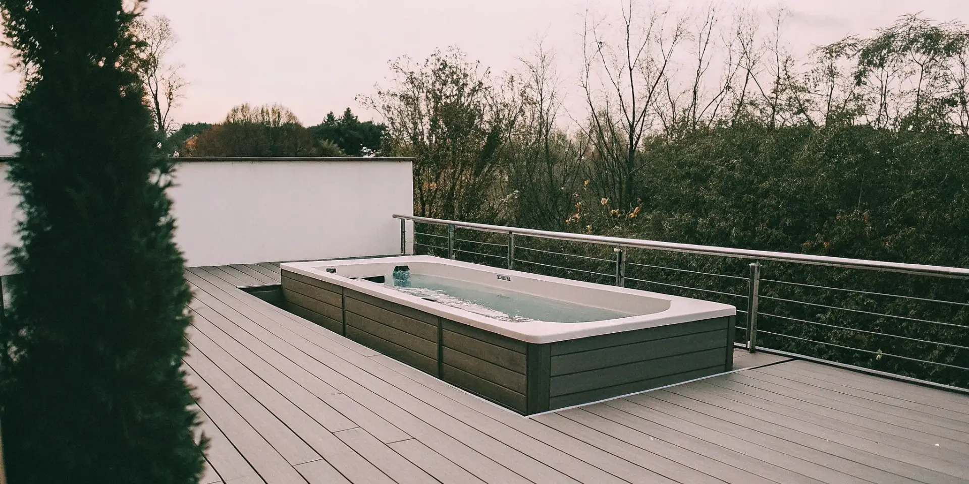 Wellness swim spa for home fitness and relaxation on a backyard deck.