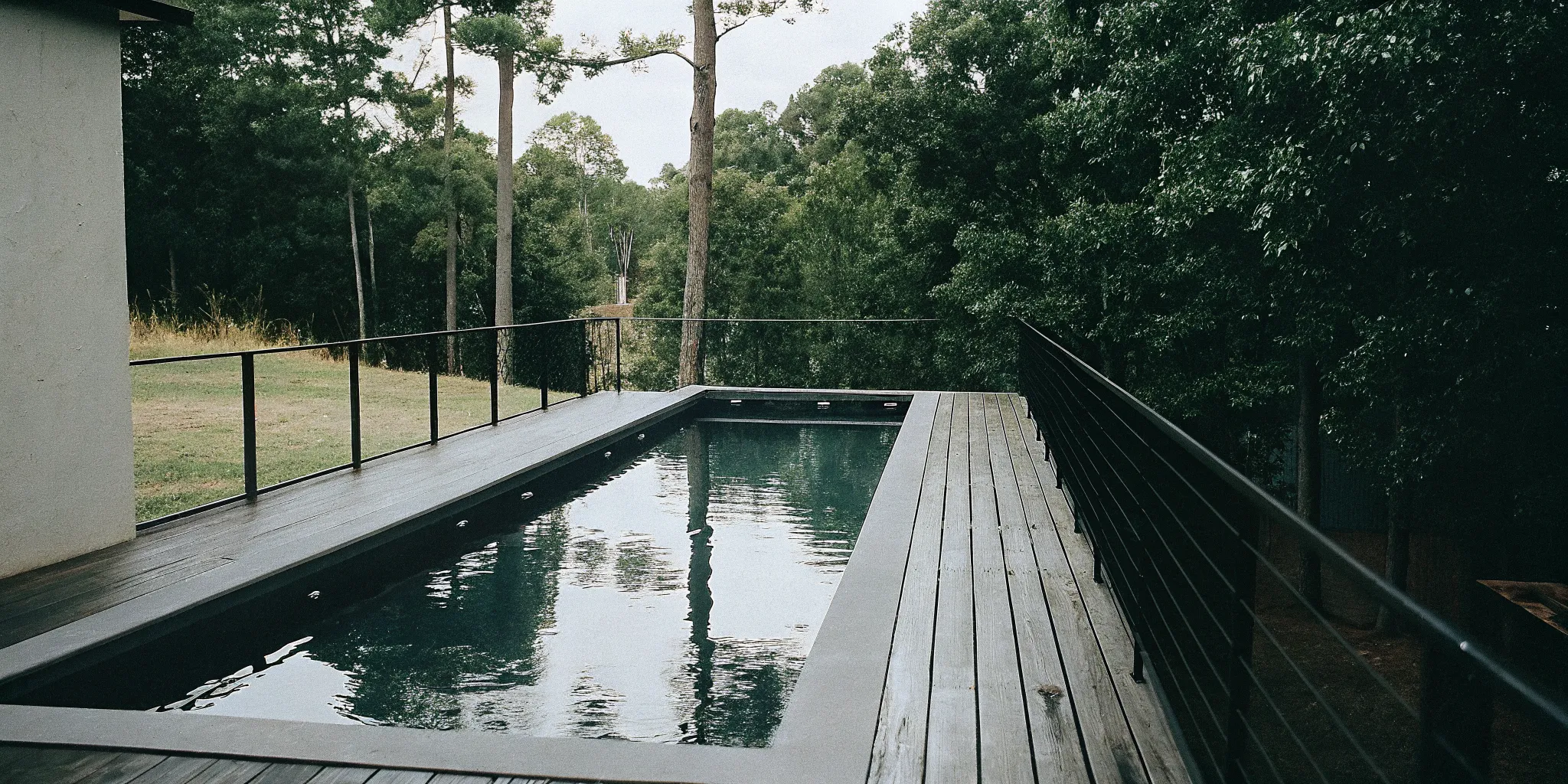 Above ground lap pool with a wood deck installed in a Rock Hill, SC backyard.