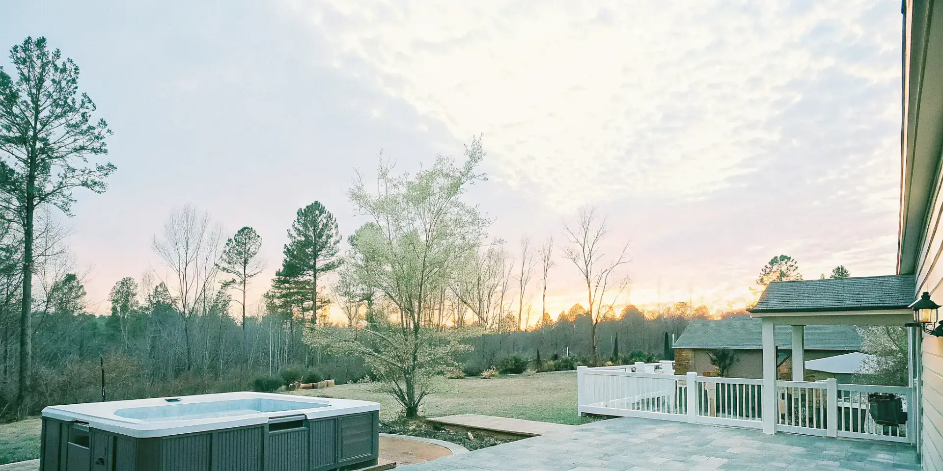 Hot tub and swim spa in a landscaped Carolina backyard