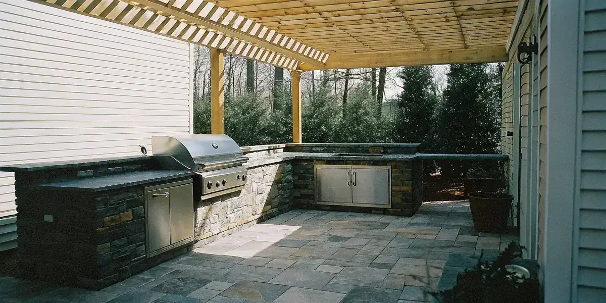 Outdoor kitchen ventilation for covered patios with grill island and vent hood