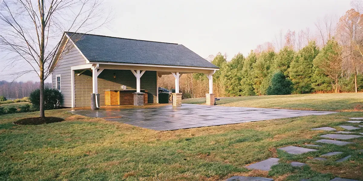 Outdoor living project in North Carolina featuring a custom paver patio with outdoor kitchen and landscaped backyard