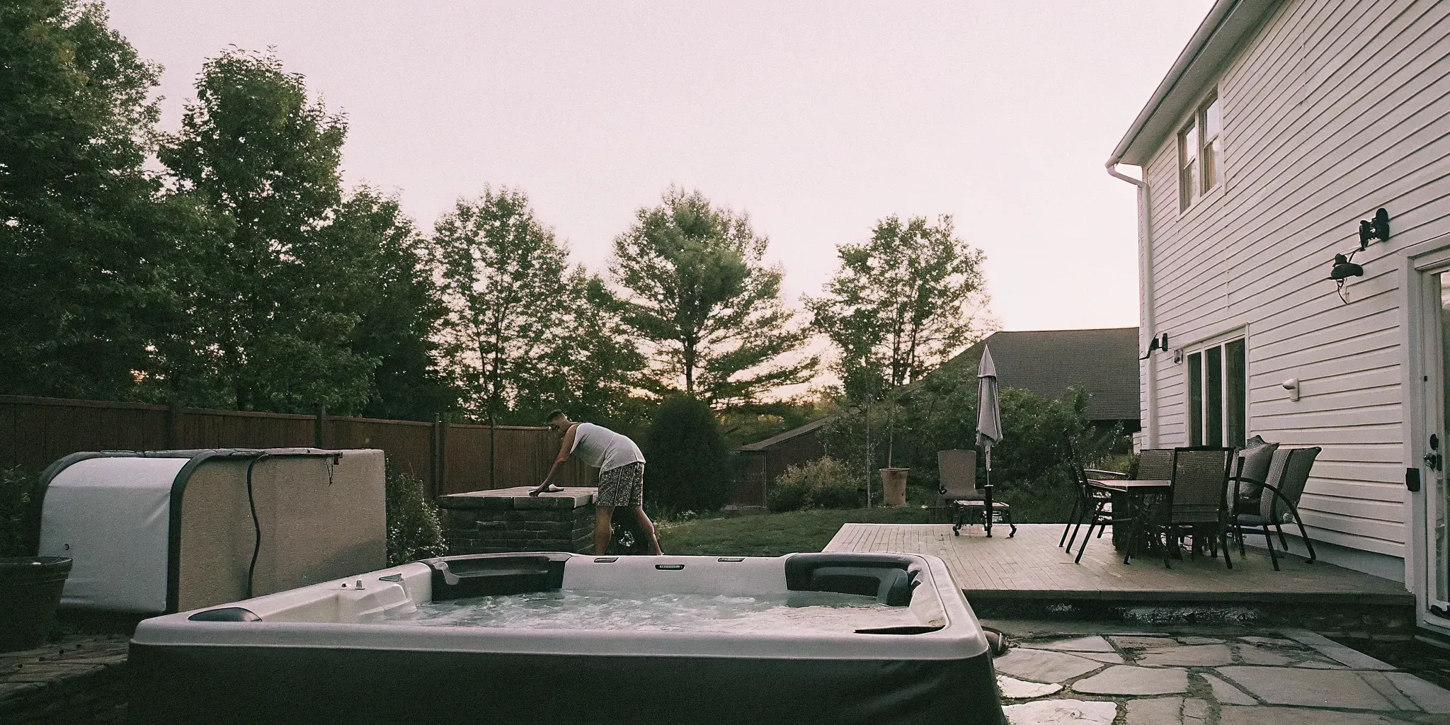 Homeowner following a hot tub maintenance schedule in a Carolina backyard